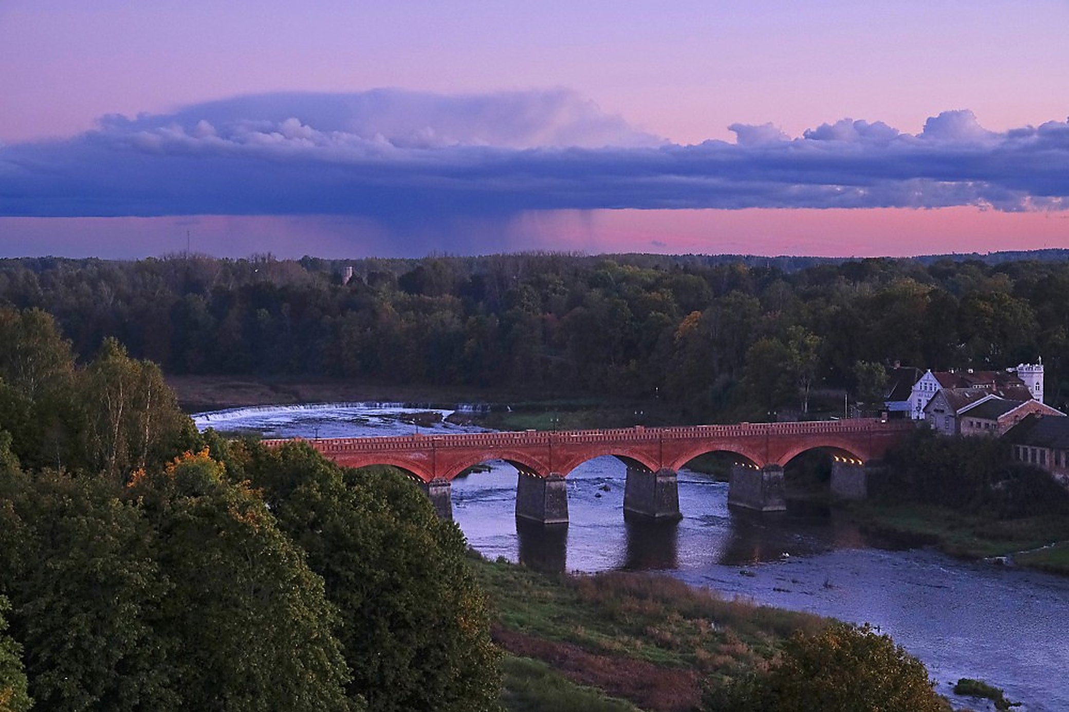 The last half hour before sunset, when the brick turns deep red and the whole bridge sits in the water.