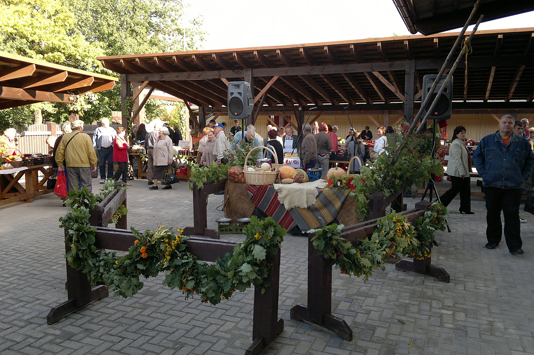 Market day under the canopy. Worth timing a morning around if you are cooking.