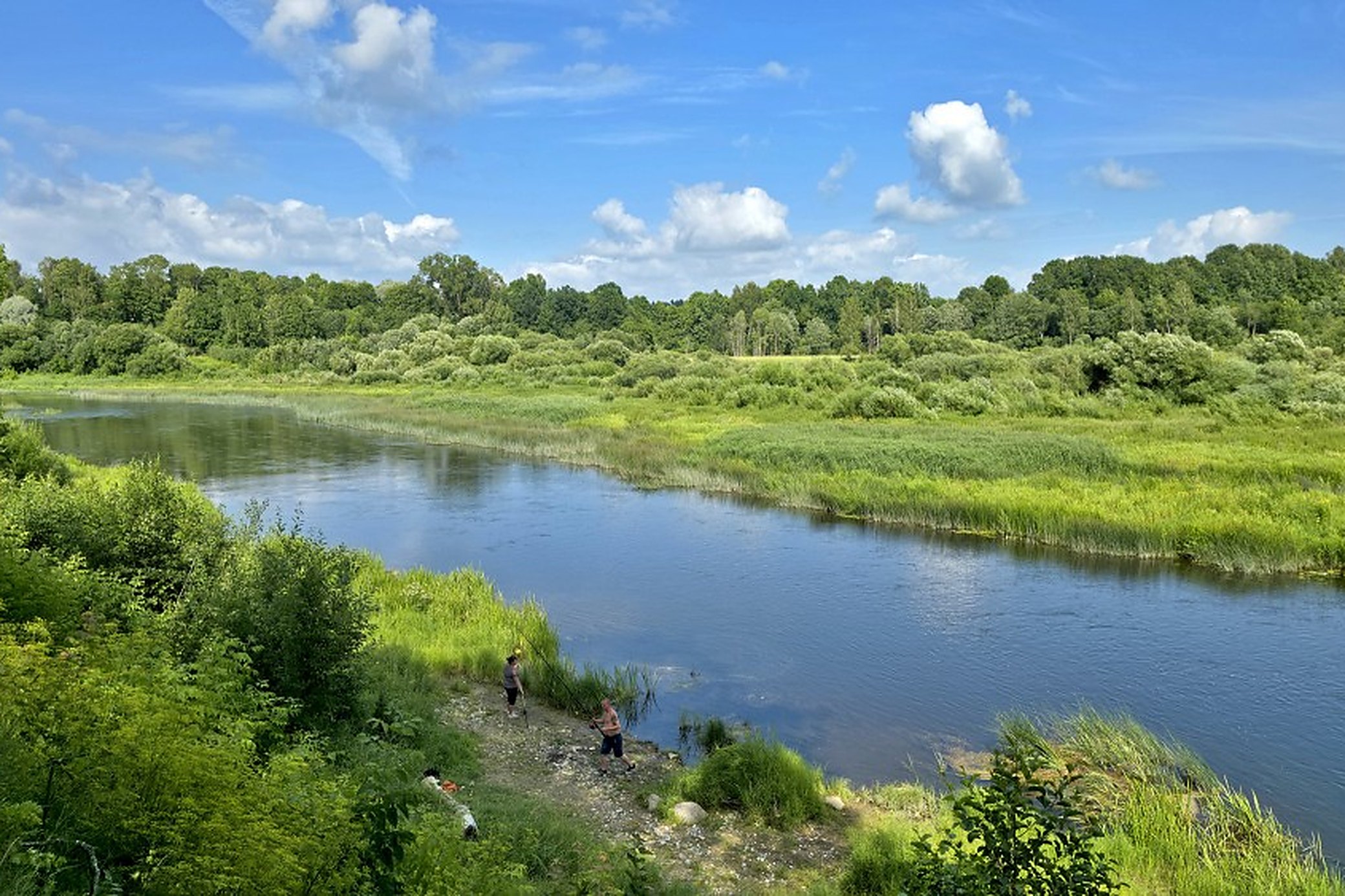 The far bank, reached over the brick bridge. Anglers are on it in most weather.