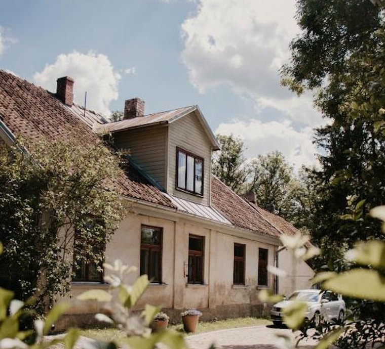 The house from the garden — tiled roof, dormer window and the drive